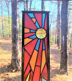 a colorful stained glass window in the woods