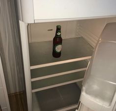 a beer bottle is sitting in the fridge