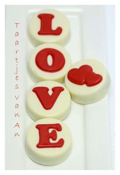 red and white buttons with the word love spelled out in large letters on a plate