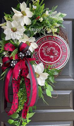 a wreath on the front door decorated with flowers