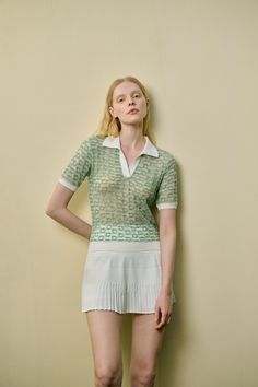 Lightweight knit Semi sheer Polo color Contrast trim Regular fit This light green, semi-sheer top features a classic polo collar, with white trim on the collar, cuffs, and hem for a fresh, stylish contrast. The breathable, lightweight fabric ensures comfort and ease, making it an ideal choice for pairing with a mini skirt. Embrace the sporty casual vibe with this versatile piece, perfect for any relaxed day out.