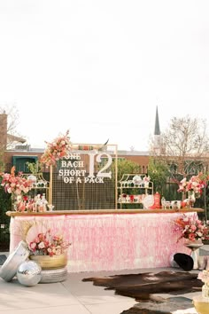 a pink and white table with flowers on it