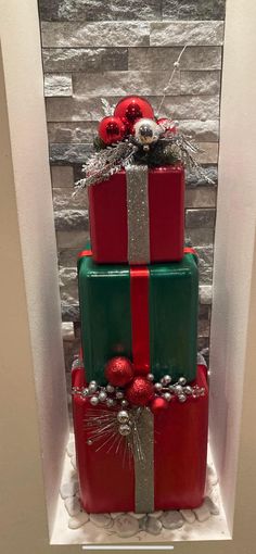 a three tiered christmas cake decorated with red and green presents