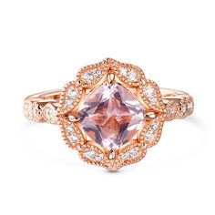 Crafted with precision and passion, the morganite ring is a symbol of love, beauty, and timeless style. Nestled at its heart is a magnificent cushion-cut morganite, captivating with its ethereal beauty. Surrounding this exquisite stone is a delicate halo of white stones, meticulously crafted in the form of enchanting floral motifs. With every glance, the morganite ring tells a story of grace and femininity. The soft blush hues of the morganite evoke a sense of romance, while the intricate floral Rose Gold Topaz Ring With Morganite And Accent Stones, Rose Gold Rings With Diamond Accents And Morganite, Heirloom Jewelry With Round Cut Morganite, Heirloom Morganite Jewelry With Round Cut, Luxury Cushion Cut Morganite Jewelry, Luxury Morganite Cushion Cut Jewelry, Exquisite Pink Morganite Jewelry, Luxury Morganite Cushion Cut Rings, Elegant Morganite Cushion Cut Rings