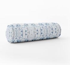 a rolled up yoga mat with blue and white designs on it, against a white background