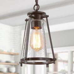 a light fixture hanging from the ceiling in a kitchen