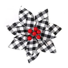 a black and white checkered flower with red berries on it's center piece