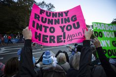 a group of people holding up signs in the street