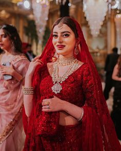 a woman in a red bridal outfit