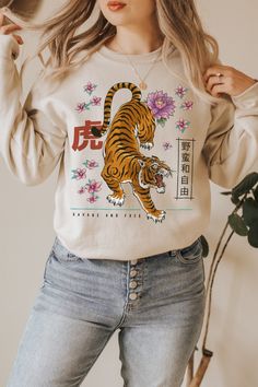 Japanese Streetwear Tiger design style for teen girls, women, alternative boys & men who loves Tigers & Soft Grunge apparel. Also a great Chinese Zodiac 2022 present to Celebrate Lunar New Year 2022. Also available on: t-shirts: https://www.etsy.com/listing/1156261109/tiger-graphic-tee-chinese-new-year-of https://www.etsy.com/listing/1142305814/tiger-graphic-tee-chinese-new-year-of dark version sweatshirt: https://www.etsy.com/listing/1156987865/tiger-sweatshirt-lunar-new-year-of-the Hoo Tiger Graphic Tee, Korean Tiger, Women Alternative, Orientation Outfit, Tiger Hoodie, Harajuku Hoodie, Design Japonais, Tiger Graphic, Geaux Tigers