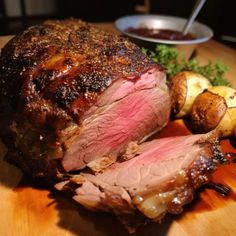 roast beef and potatoes on a wooden cutting board