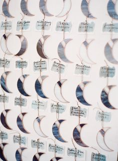 a wall covered in lots of different types of paper crescents with writing on them