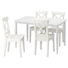 a white table and four chairs are shown