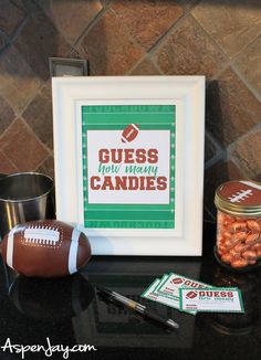 there is a football and some candy in front of a picture frame on the table