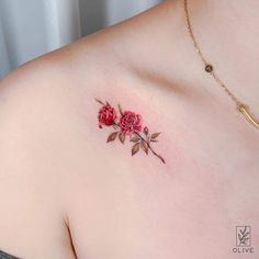 a woman's chest with red roses on it