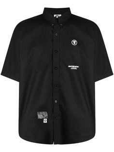 logo-patch short-sleeve shirt from AAPE BY *A BATHING APE® featuring black/white, cotton, logo patch at the chest, logo patch to the front, logo print to the front, logo print to the rear, classic collar, front button fastening, short sleeves and rear curved hem. Collared Cotton Shirt With Logo Print, Cotton Collared Shirt With Logo Print, Collared Cotton Short Sleeve Shirt For Streetwear, Collared Cotton Shirt With Logo, Button-up Cotton T-shirt For Streetwear, Cotton Button-up T-shirt For Streetwear, Short Sleeve Tops With Logo Patch For Summer, Cotton Short Sleeve Streetwear Shirt, Cotton Short Sleeve Button-up Shirt For Streetwear