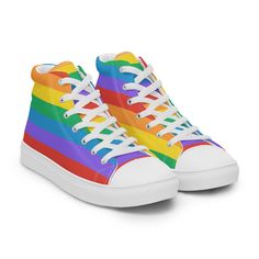 Rainbow LGBTQ+ Women's High Top Canvas Sneakers. Don't forget to treat your feet with care! The classic, stylish high top canvas shoes will be a great addition to your wardrobe. * 100% polyester canvas upper side * Ethylene-vinyl acetate (EVA) rubber outsole * Breathable lining, soft insole * Faux leather toe cap * White laces * Padded collar, lace-up front * Blank product sourced from China Important: This product is available in the following countries: United States, Canada, Australia, United Kingdom, New Zealand, Japan, Austria, Andorra, Belgium, Bulgaria, Croatia, Czech Republic, Denmark, Estonia, Finland, France, Germany, Greece, Holy See (Vatican city), Hungary, Iceland, Ireland, Italy, Latvia, Lithuania, Liechtenstein, Luxemburg, Malta, Monaco, Netherlands, Norway, Poland, Portugal Pride Shoes, Cap White, Rainbow Flag, Canvas Sneakers, Gay Pride, Canvas Shoes, Mens Shoes Sneakers, High Top, High Tops