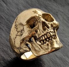 "Custom made to order One of my Solid Gold ULTIMATE SKULL RINGS - one big hunk of GOLD! I designed this classic to have a lower profile to make it more \"pocket friendly\". Unbelievable detail. Heirloom quality Hand carved in wax by me in my studio in Southern California , then cast (by me) in solid 14K gold. The inside is mirror polished for comfort Extremely comfortable to wear. 100% SOLID 14K yellow (or 14K white) gold Skull Ring - no backside hollowing. Weighs 43 grams (almost 1.5 ounces) of Skeleton Ring, Skull Rings, Metal Skull, Biker Jewelry, Gold Skull, Vintage Skull, Ring Mens, Punk Jewelry, Jack Sparrow