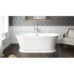 a white bath tub sitting on top of a hard wood floor next to a chair