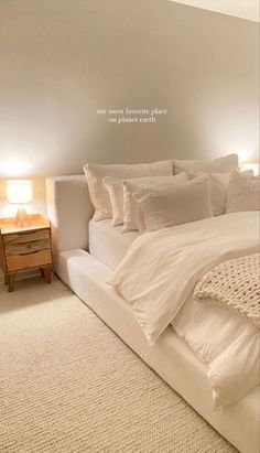 a bed with white linens and pillows in a room that looks like an attic