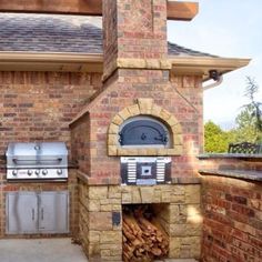 an outdoor kitchen with grill and oven built into it