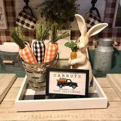 a tray with carrots, an easter bunny and a sign on it that says carrots