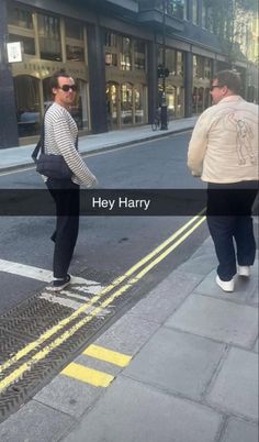 two men crossing the street in front of a building with words that read hey harry