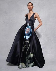 The Arabella Taffeta Gown is a design masterpiece, perfect for those opulent black-tie events. The large Japanese peony exudes a sense of dark romance, that tells a captivating visual story. The simplicity of the gown's silhouette is balanced by its dramatic sense of presence, and the beautifully designed back mirrors a deep-v front. The floral painting appears alive, gracefully trailing up the dress, making this piece a true show stopper. Cinched with a crystal buckle belt. 100% POLYESTER / LINING: 100% RECYCLED POLYESTER Japanese Peony, Eye Model, Taffeta Gown, Borgo De Nor, Visual Story, Fall Lookbook, Art Museums, High Neck Sweater, Long Sleeve Sweater Dress