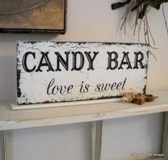 a sign that says candy bar love is sweet sitting on a shelf next to other items