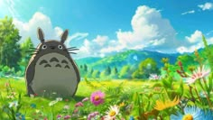 totoro sitting in the grass surrounded by wildflowers