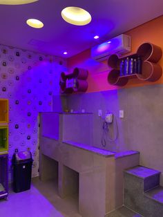 a room with purple lighting and various items on the walls, including a counter top