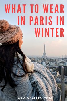 a woman looking at the eiffel tower with text overlay that reads what to wear in paris in winter