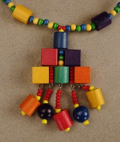 A stunning colorful Studio handcrafted artistic necklace with a rich combination medley of different sized wooden beads in brilliant red blue yellow green cylinders rectangles andround beads necklace as you can see from the pictures. It is in excellent vintage condition with a nicely closing tieback as seen in photo. It measures 14 inches long and is 3 inches at it's widest. A welcome one of a kind necklacesummer present that will delight it's new owner! Unique Multicolor Rectangular Necklace, Unique Multicolor Necklace, Multicolor Rectangular Beaded Necklaces, Artistic Necklace, Colorful Studio, Seashell Pendants, Coloring Apps, Cut Out Design, Beads Necklace