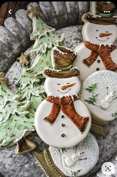 some decorated cookies in the shape of snowmen