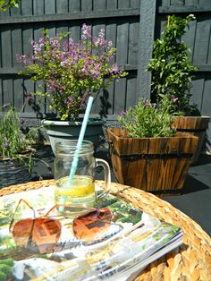 a table with some glasses on top of it and flowers in the backround