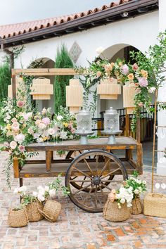 an old wagon is decorated with flowers and greenery