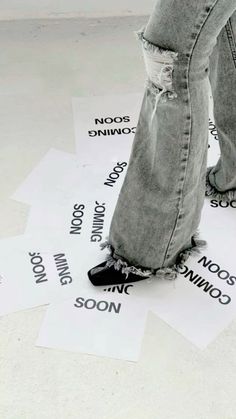 a person standing on top of some paper with words written on it and one foot in the middle