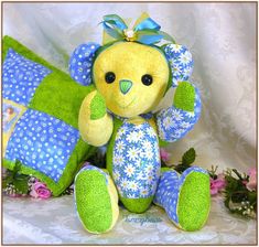 a stuffed teddy bear sitting next to flowers