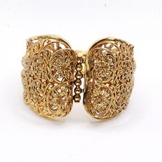 "DESCRIPTION: Step into the charm of the 1970s with this vintage gold-tone filigree bracelet. Crafted with meticulous attention to detail, the bracelet features intricate filigreed patterns adorning the entire piece. The centerpiece showcases a captivating butterfly accent, adding a whimsical touch to the design. In mint condition, this bracelet has been well-preserved over the years, maintaining its original allure. With a push-pull clasp for secure fastening, this bracelet measures 7 1/2\" in Gold Cuff Bracelet With Intricate Design, Vintage Gold Bracelets With Intricate Design, Antique Gold Cuff Bracelet With Filigree, Adjustable Gold Filigree Bracelets, Gold Victorian Cuff Bracelet With Intricate Design, Vintage Yellow Gold Cuff Bracelet With Intricate Design, Vintage Gold Bangle With Intricate Design, Elegant Brass Gold Bracelet With Intricate Design, Ornate Yellow Gold Bracelets With Intricate Design