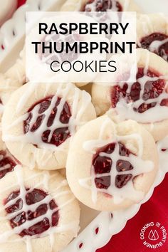 raspberry thumbprints with white icing are on a plate