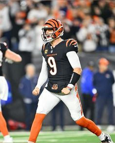 the football player is wearing an orange and white uniform