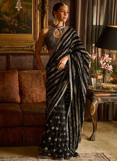 Our Black Embroidered Velvet Saree includes a velvet top and velvet with net saree with santoon inner. Embroidery is present on this style using zari, sequins, and stone work. Like all of our pieces, this piece is made in India and checked by hand to ensure high quality. Black Saree With Blouse, Velvet Sari, Draped Saree Gown, Saree Gowns, Velvet Saree, Dhoti Saree, Cotton Sarees Handloom, Drape Sarees, Saree Gown