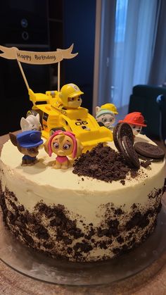 a birthday cake with cars and cookies on it