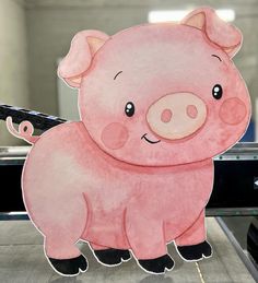 a pink pig cut out sitting on top of a counter