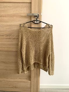 a sweater hanging on a wooden door