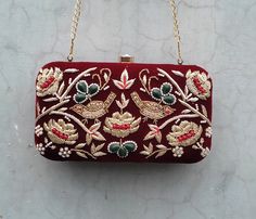 Bridal embroidery clutch on Mehroon velvet fabric. COLOUR CAN BE CUSTOMIZED. Details : 1. 100% Hand embroidery 2. Material : Velvet 3. Dimensions : approximately 8*4 inches 4. Detachable long golden chain 5. Double side zardosi work  on the box. 6. Clutch Size 8*4 approx. 7. With Clutch Handle and Sling Chain Traditional Velvet Clutch For Formal Occasions, Velvet Clutch For Wedding, Evening Clutch With Multicolor Embroidery And Handwork, Festive Multicolor Embroidered Handwork Clutch, Velvet Rectangular Wedding Bags, Rectangular Velvet Wedding Bags, Handmade Velvet Wedding Bags, Handmade Velvet Wedding Bag, Rectangular Velvet Wedding Bag