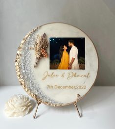 a wedding cake with a photo on it and a flower next to it that reads, you're & diamond