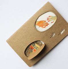 a card with an image of a hand print on it and a paper plate next to it