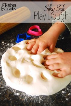 a child is playing with play dough on the counter