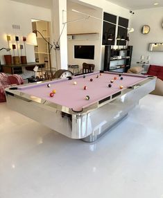 a pool table in the middle of a living room